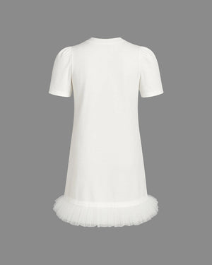 White dress with a tulle skirt on a gray background