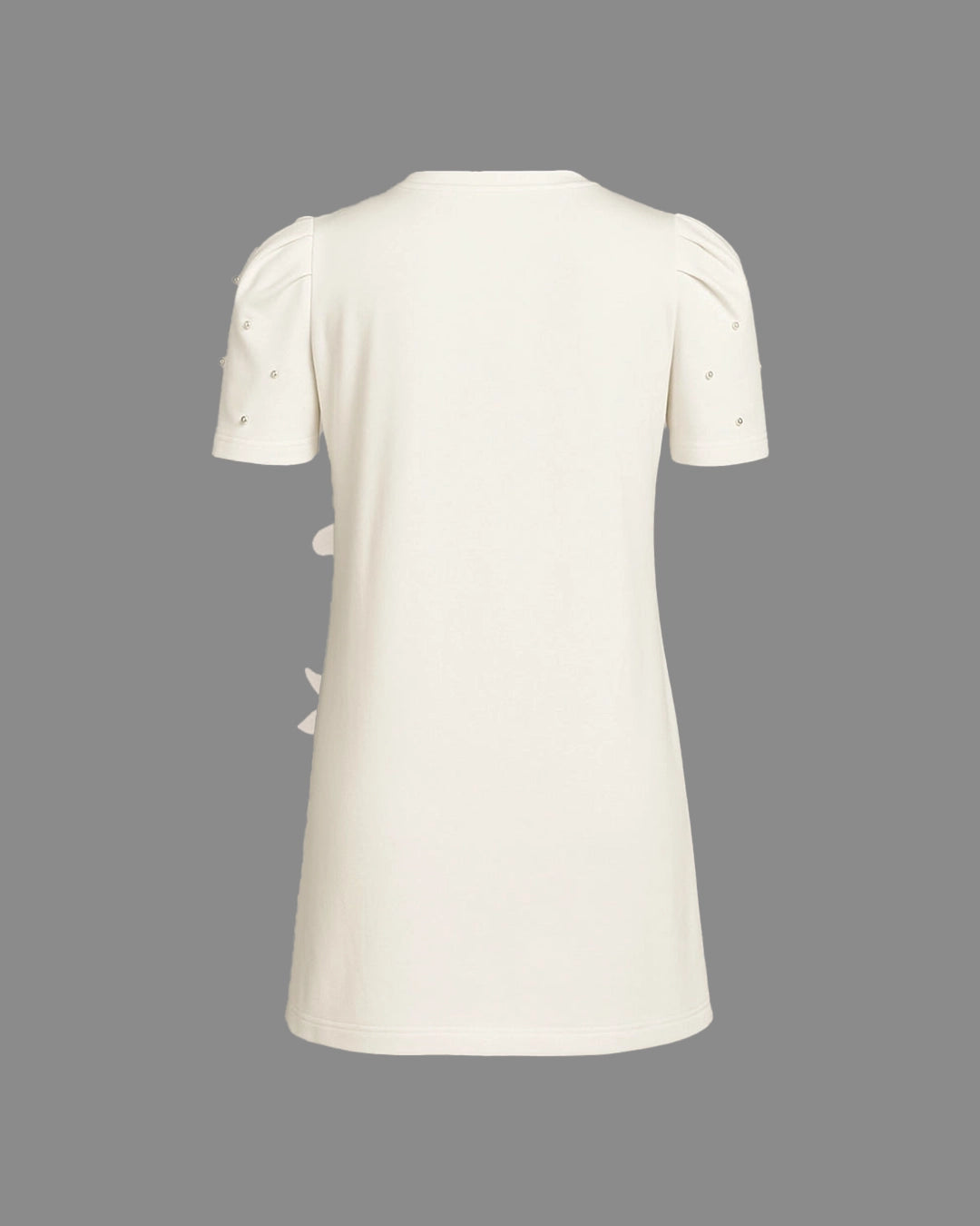 White dress with short sleeves and decorative elements on a gray background